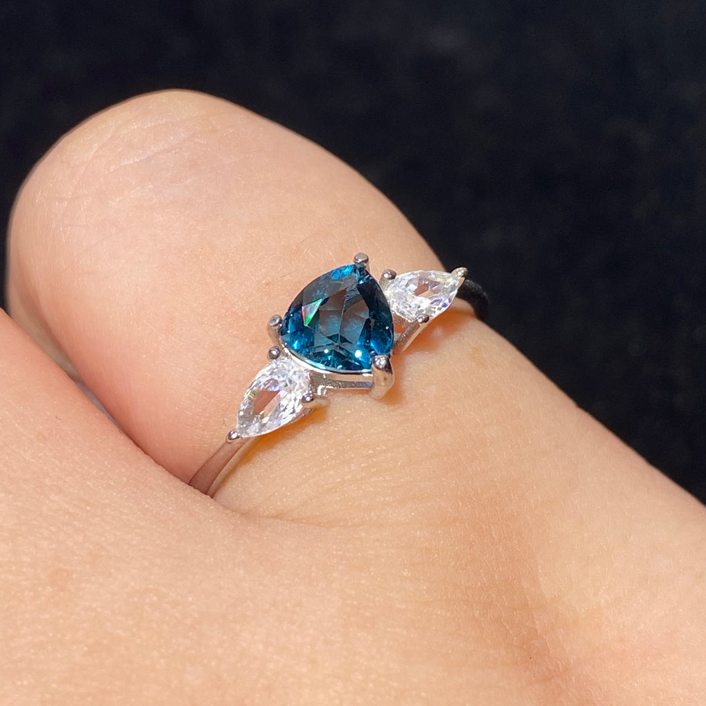 Pear London Blue Topaz Three-Stone Split Shank 925 Sterling Silver Ring Deep ocean blue teardrop main gem flanked by marquise clear zircon accent stones