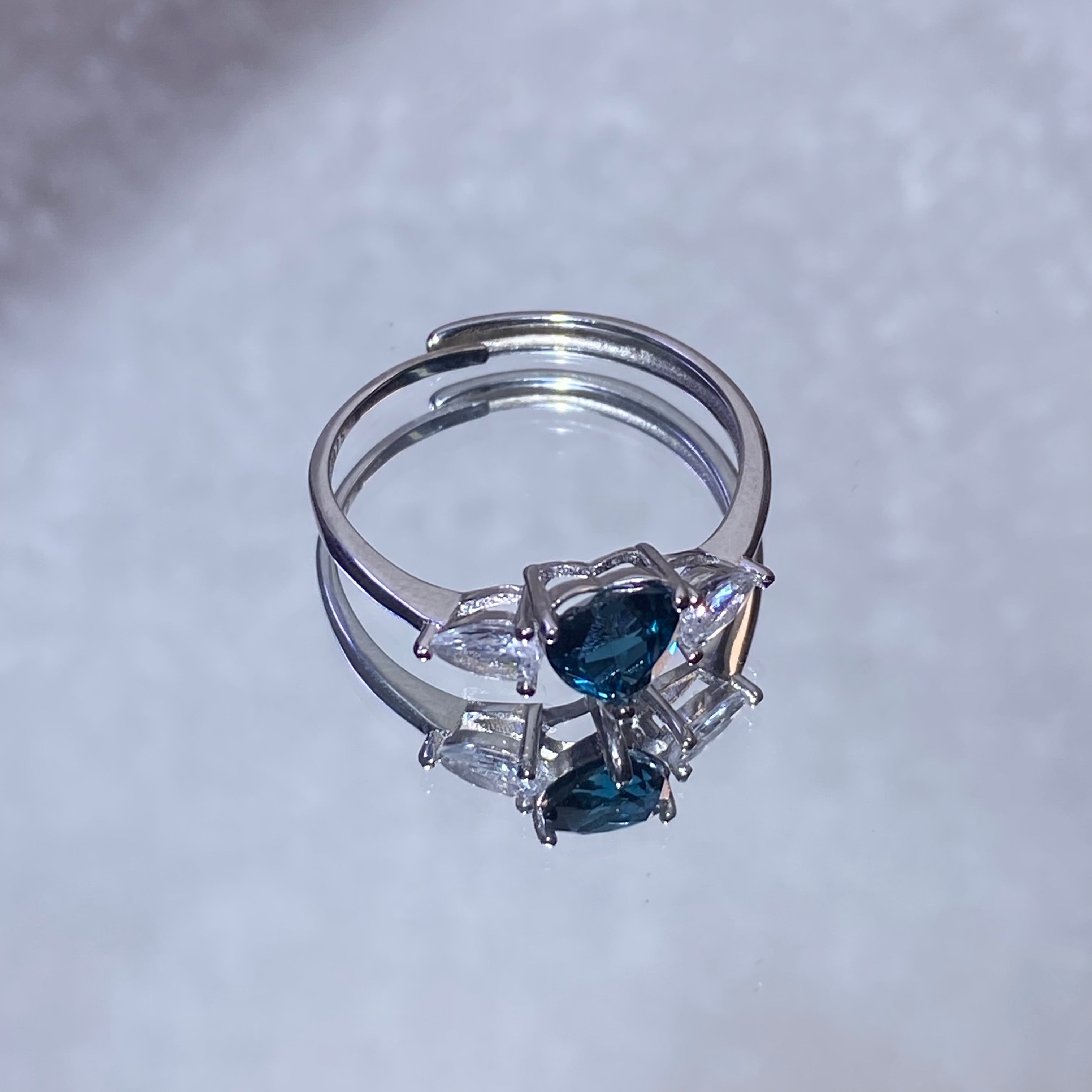 Pear London Blue Topaz Three-Stone Split Shank 925 Sterling Silver Ring Deep ocean blue teardrop main gem flanked by marquise clear zircon accent stones
