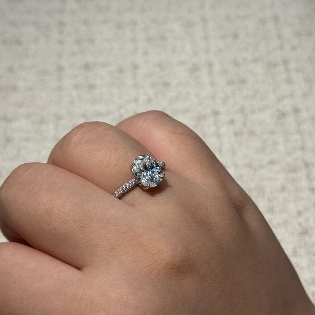 4-Prong Round Solitaire Ring with Paved Side Stones