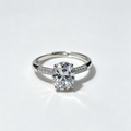 4-Prong Round Solitaire Ring with Paved Side Stones