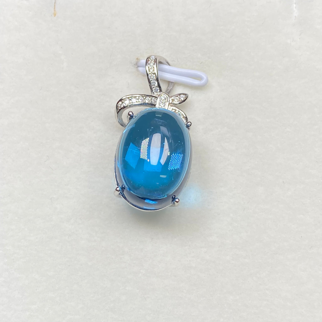 Swiss Blue Topaz Cabochon Pendant - Sterling Silver with Bow Design