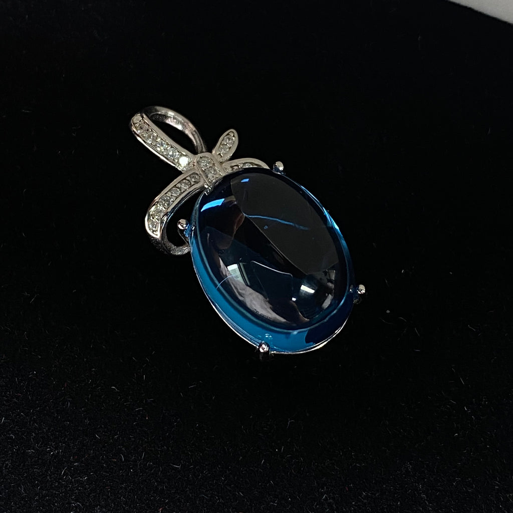 Swiss Blue Topaz Cabochon Pendant - Sterling Silver with Bow Design