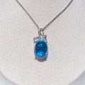 Swiss Blue Topaz Cabochon Pendant - Sterling Silver with Bow Design