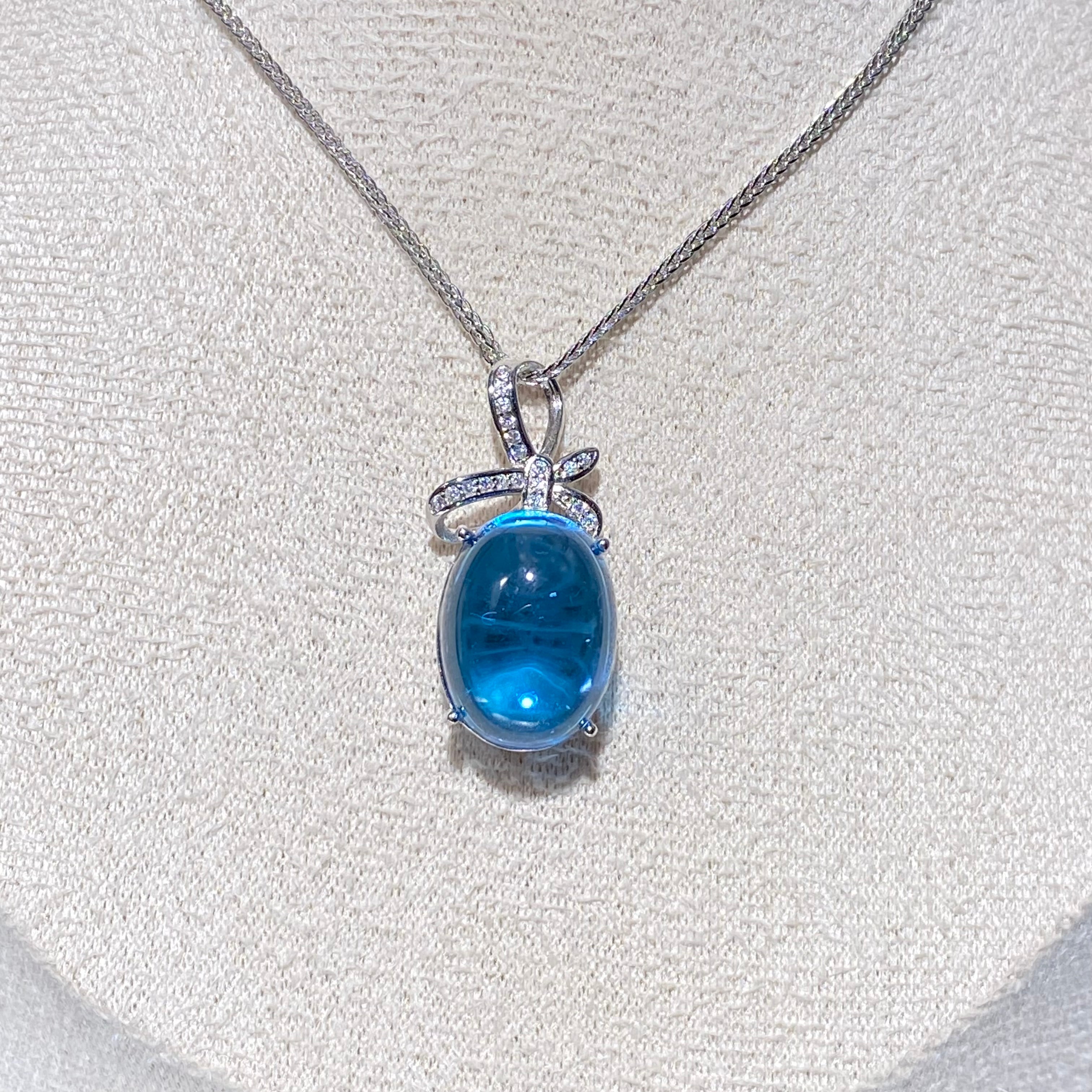 Swiss Blue Topaz Cabochon Pendant - Sterling Silver with Bow Design